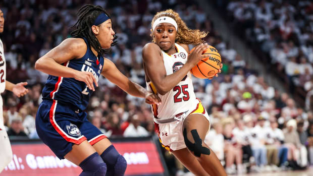 Feb 11, 2024; Columbia, South Carolina, USA; South Carolina Gamecocks guard Raven Johnson (25) drives around UConn Huskies guard KK Arnold (2) in the first half at Colonial Life Arena. 